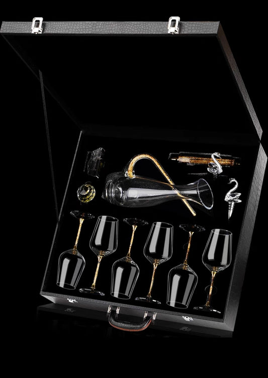 Complete luxury wine glass and decanter set with gold foil accents on black background