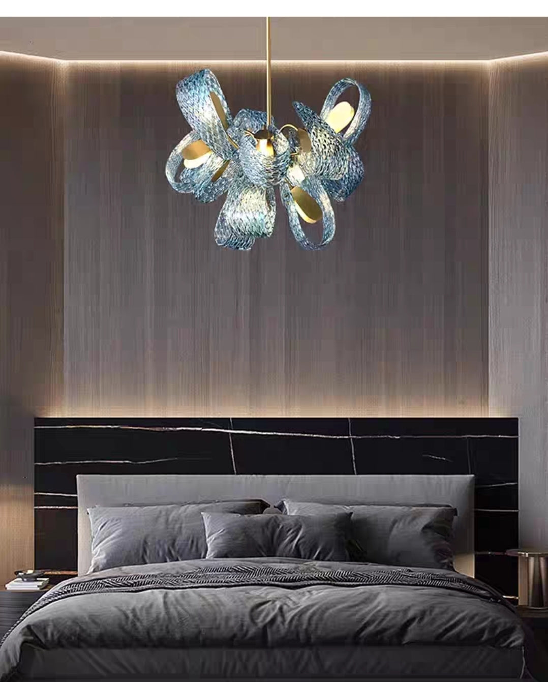 Brushed brass chandelier with glass diffusers hanging in luxury bedroom.