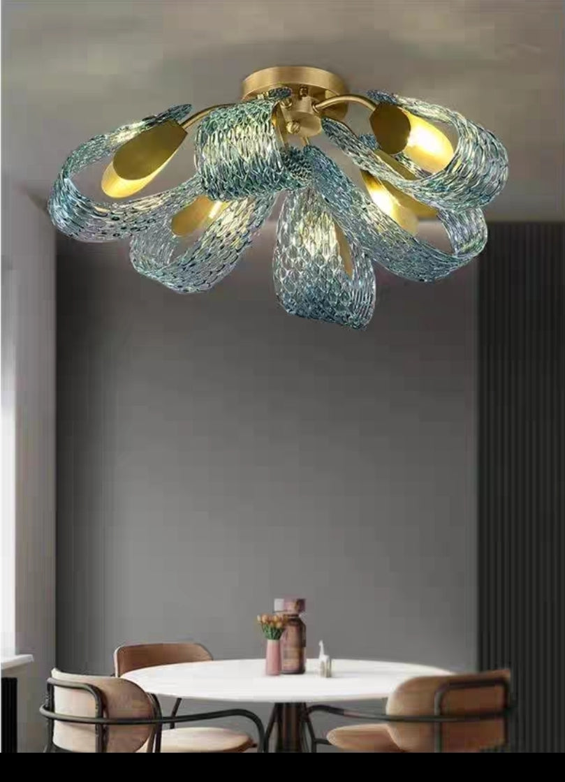Artistic brass chandelier with tri-spectrum LED in a living space.