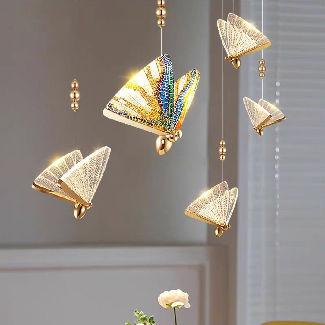 Luxury abalone crystal chandelier with gold LED lights hanging in modern dining room.