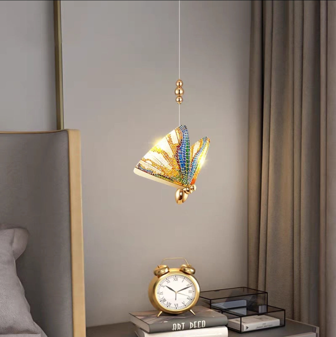 Artistic chandelier with shell inlay and cascading crystal chains in upscale bedroom.