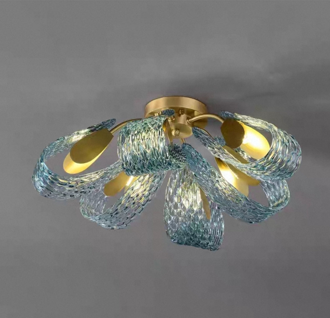 Close-up of brushed brass chandelier showcasing glass diffusers.