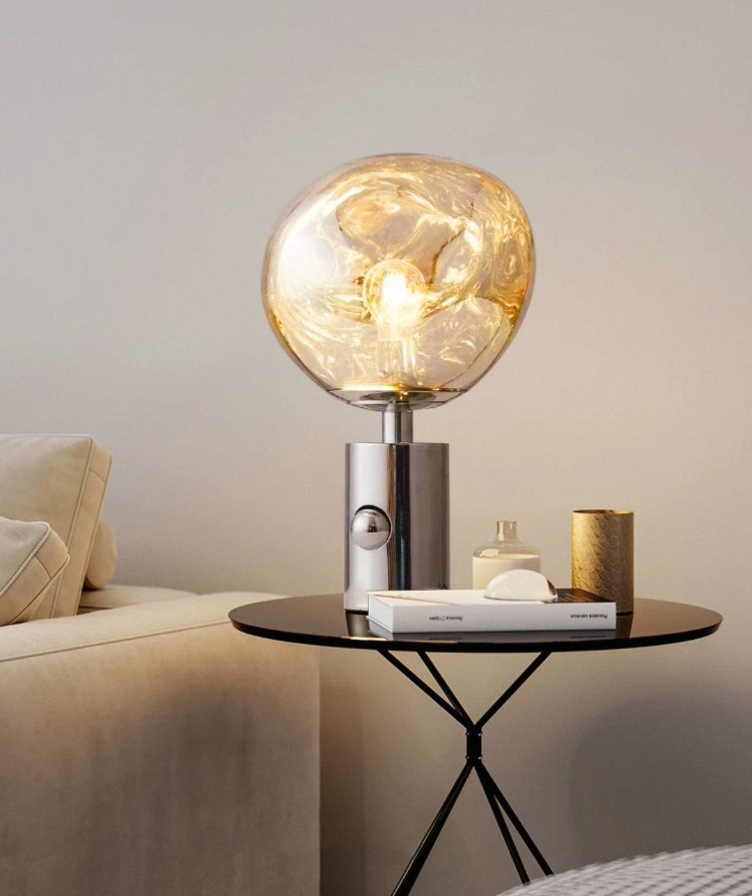 Sculptural glass bedside lamp with warm glow effect and cylindrical gold stand