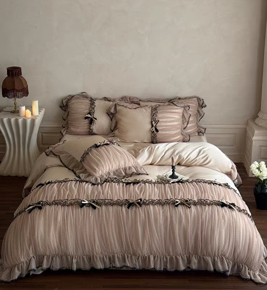 Close-up of lace-trimmed pillowcases and satin bow accents.