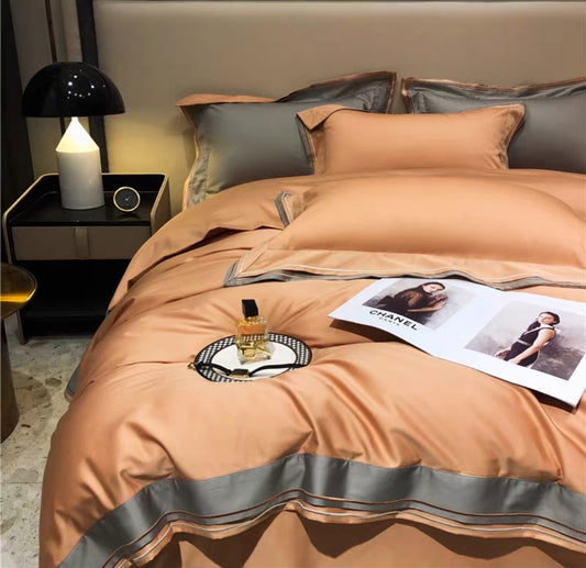 100& 100S luxury long staple bedspread with gray trim on a bed in a bedroom setting.