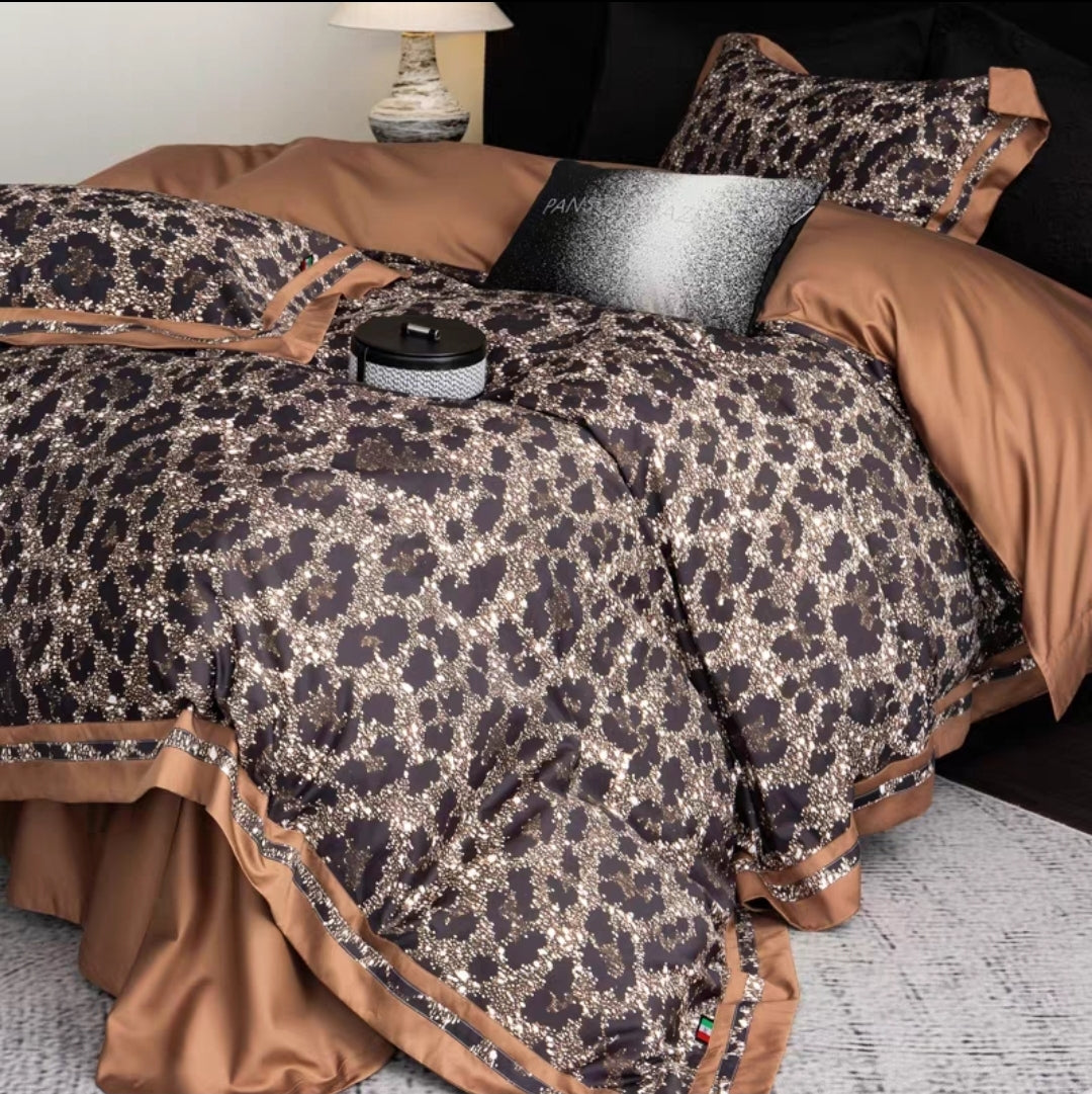 100S long staple cotton. Bed with leopard print bedding and brown pillows in a bedroom setting.