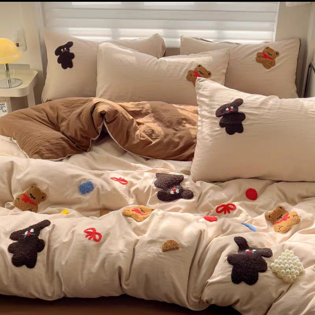 Cotton Bedding set with decorative pillows and a blanket featuring small teddy bear and flower appliqués.