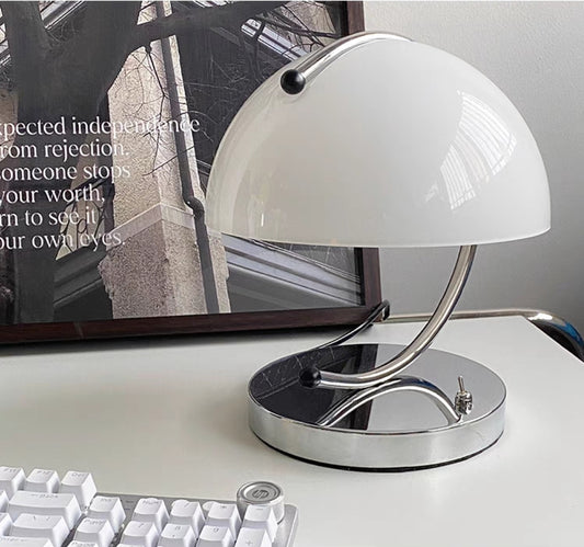 Modern  mini retro mushroom glass desk lamp on a desk with a computer monitor in the background