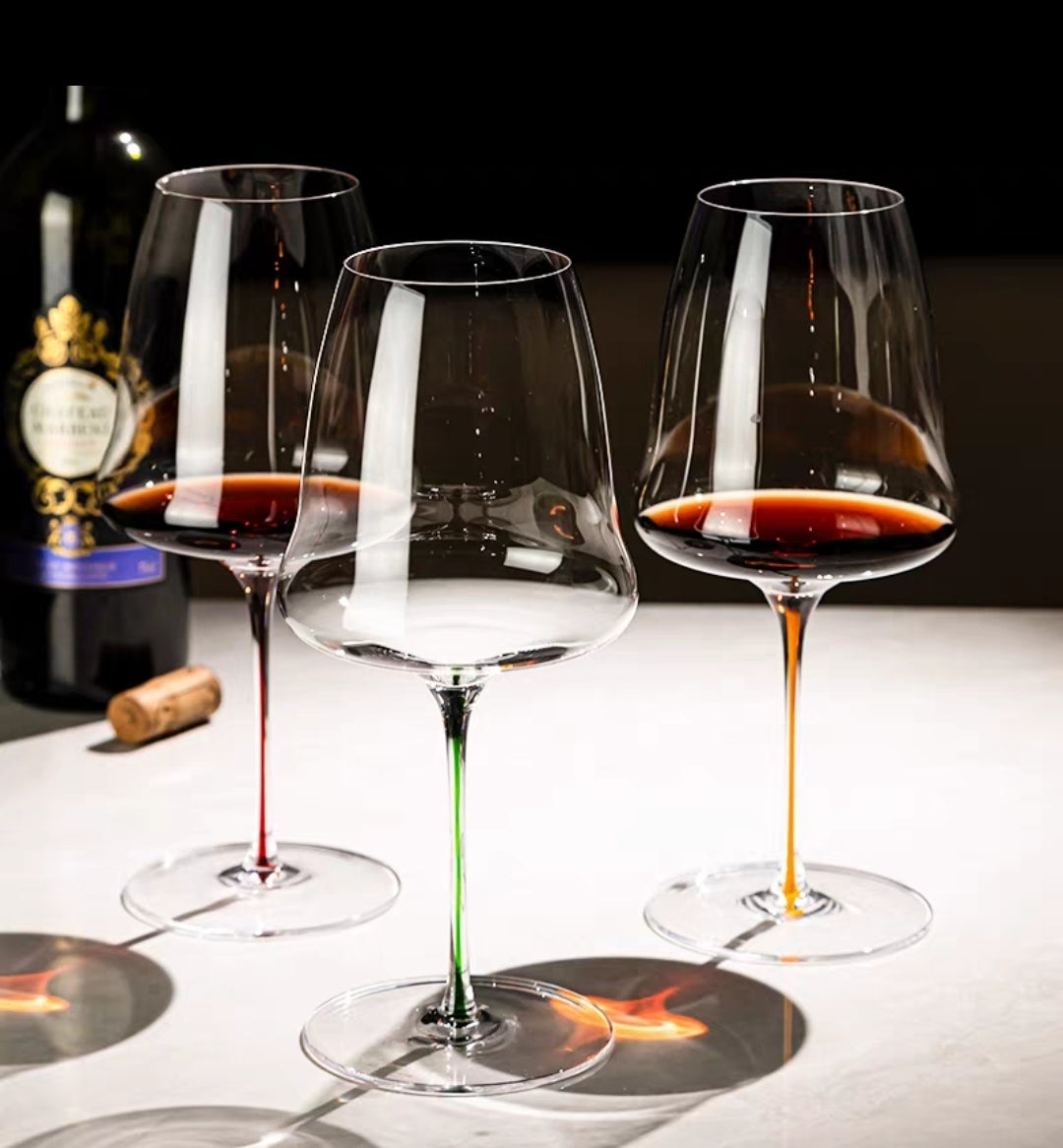 Close-up of handmade crystal wine glass with green stem