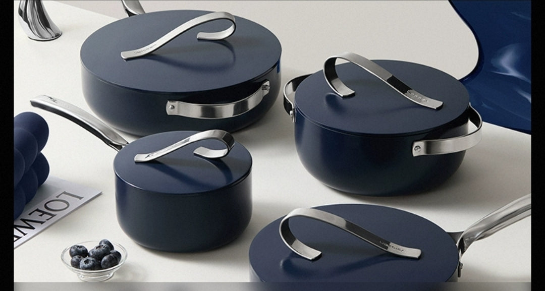 Non-stick ceramic frying pan with tomato dish, stainless steel handle, on gas stove