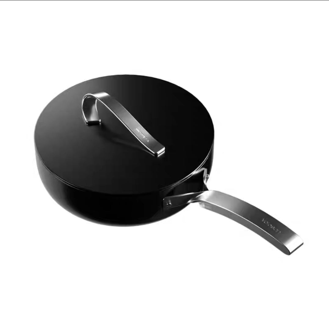 Black non-stick ceramic frying pan with a silver handle on a white background