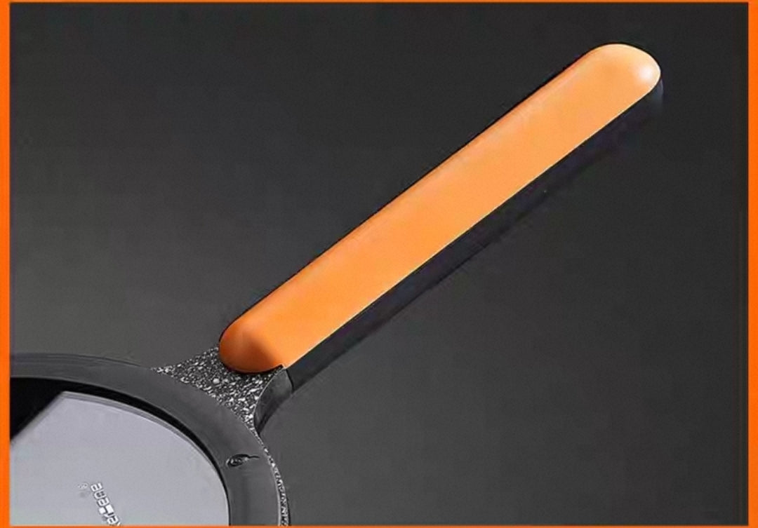 Close-up of non-stick granite cookware surface with ergonomic wooden handle