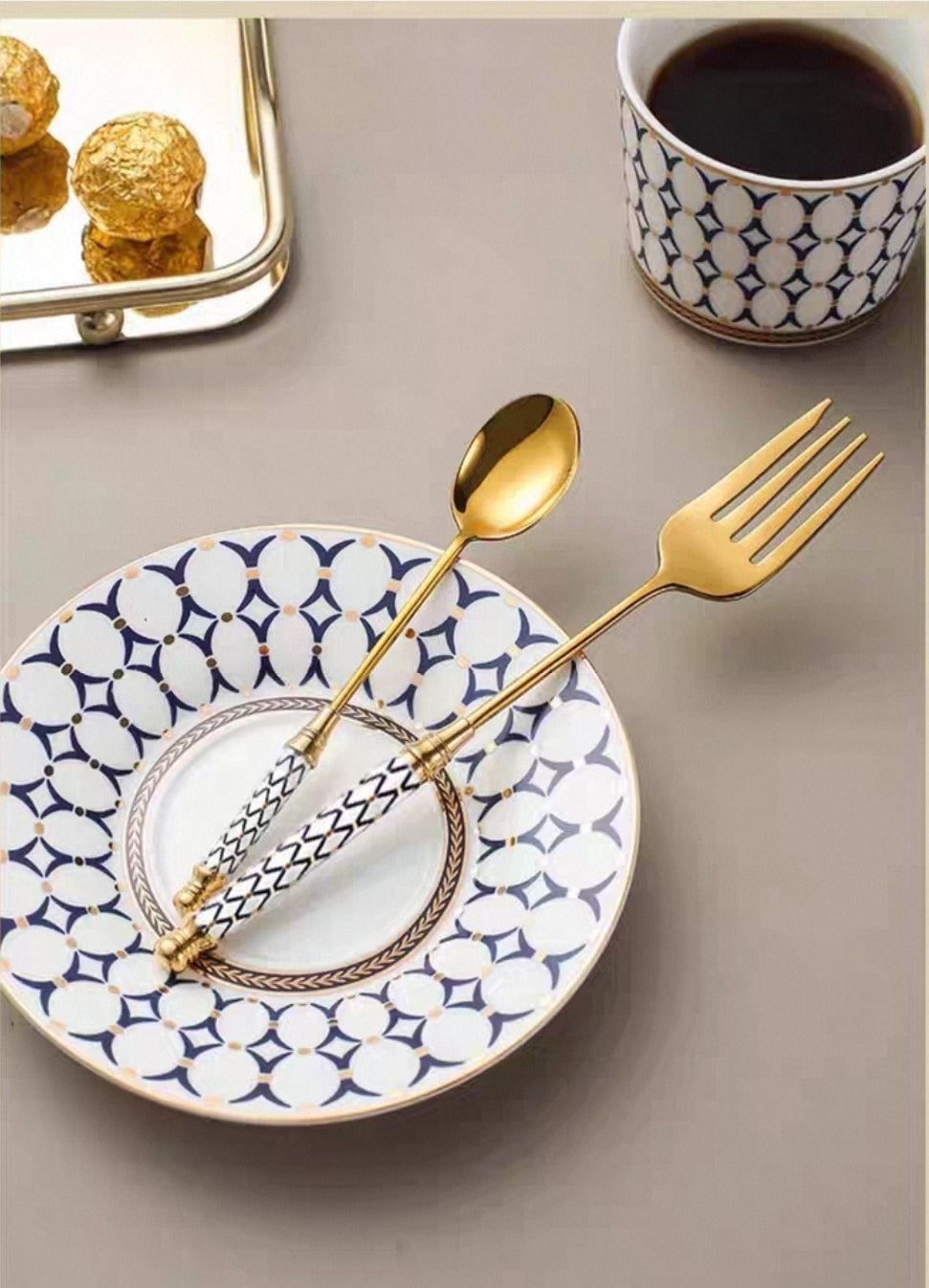 Luxury gold flatware with artisan ceramic handles displayed on table