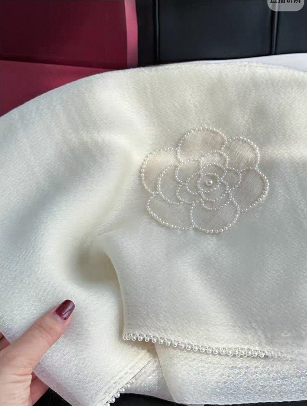 Handcrafted silk wool shawl draped over mannequin, showcasing cloud-like softness.