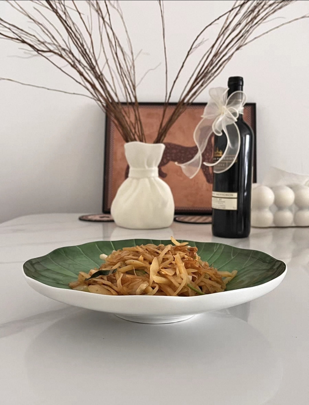 Elegant food display using green lotus leaf ceramic platter for mains and appetizers.