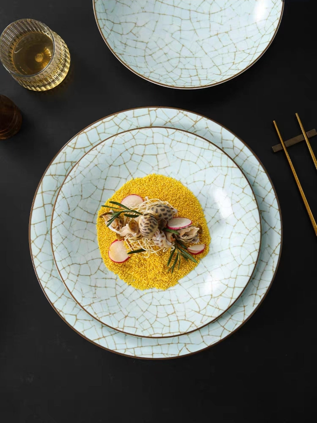 Cracked ceramic plate with a dish of food on a dark surface