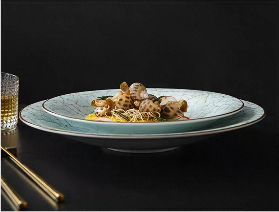 Celadon crack-glazed ceramic plates. with seafood on a decorative plate against a dark background