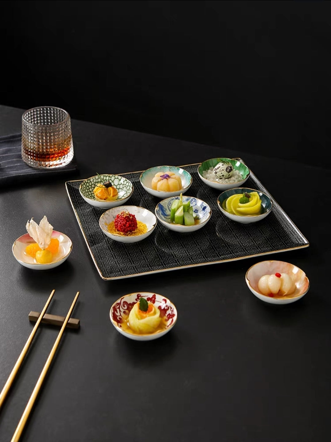 Bowls Displayed with Sushi Appetizers
"Elegant ceramic tasting bowls filled with sushi on a textured tray for fine dining presentation.