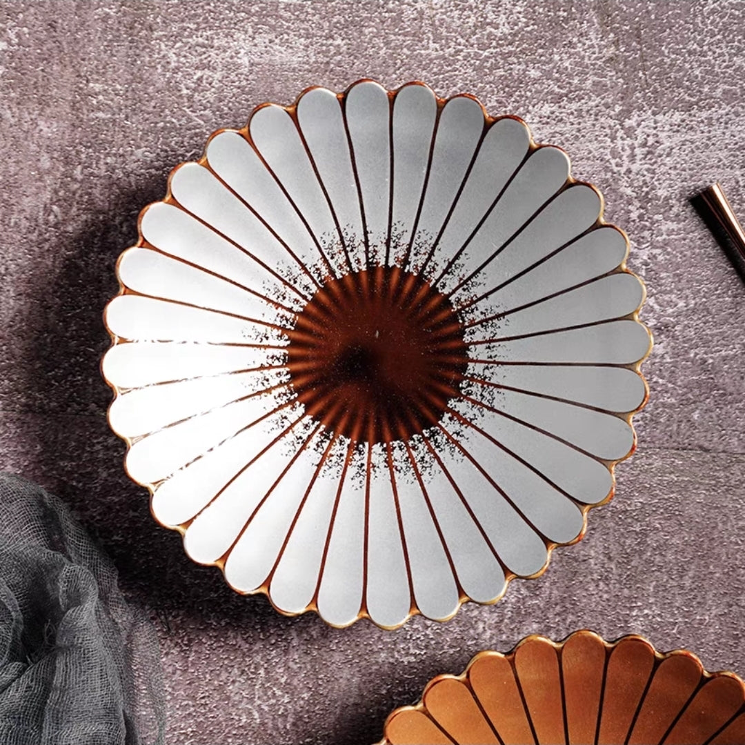 Elegant ceramic dinner plate with petal edge detail, styled in a modern dining table setup