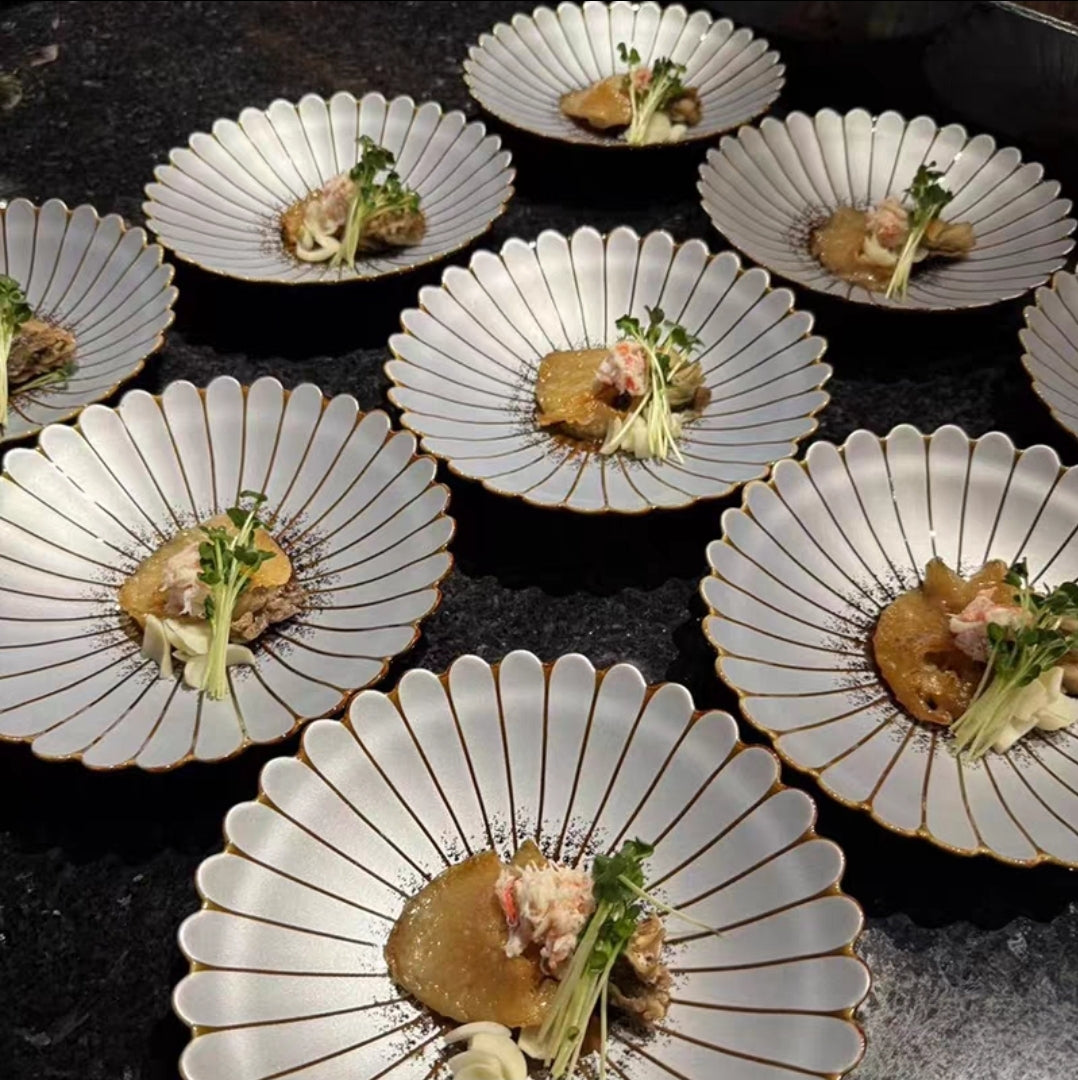Vintage petal-edge ceramic dinner plate with Japanese floral design, side view close-up