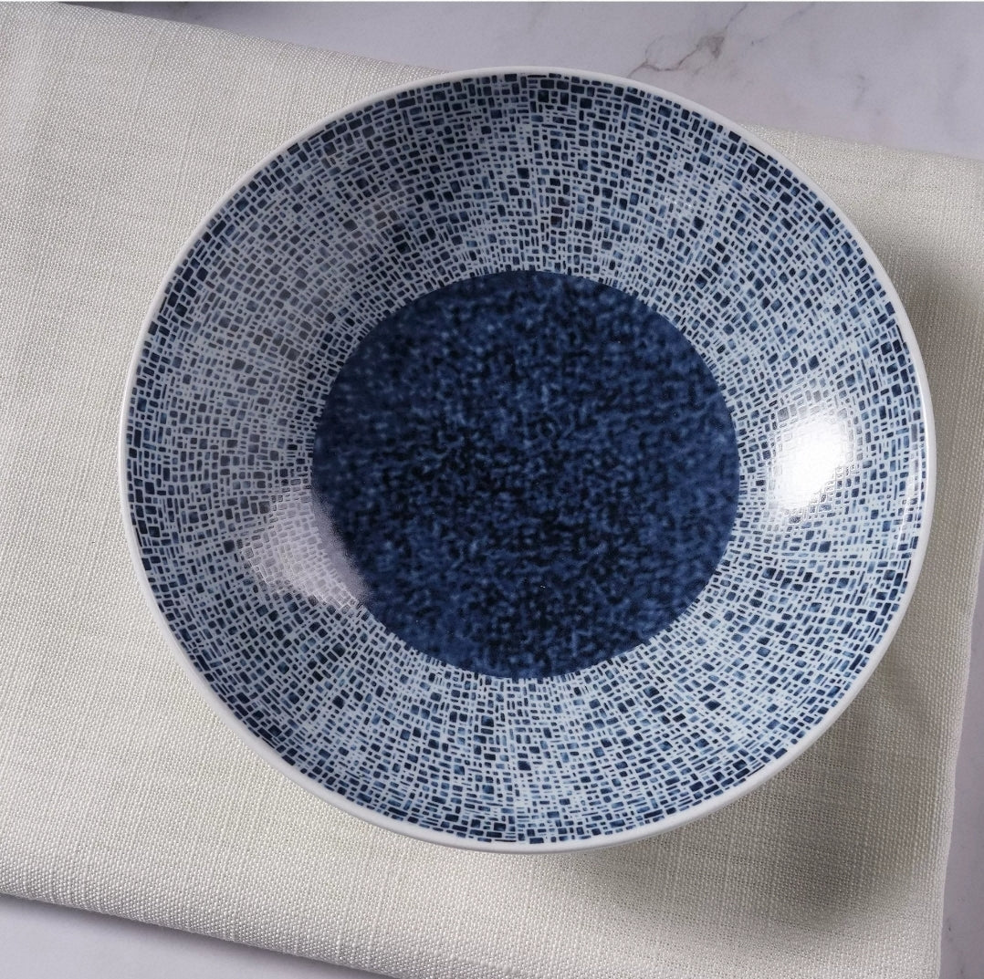 Round bone china plate with blue and white glaze for modern upscale dining presentation