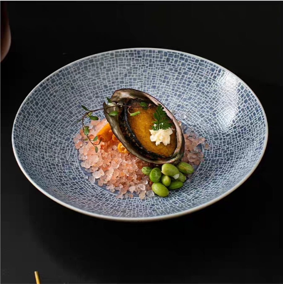 Luxury bone china dinner plate showcasing fine dining food styling in rich orange glaze