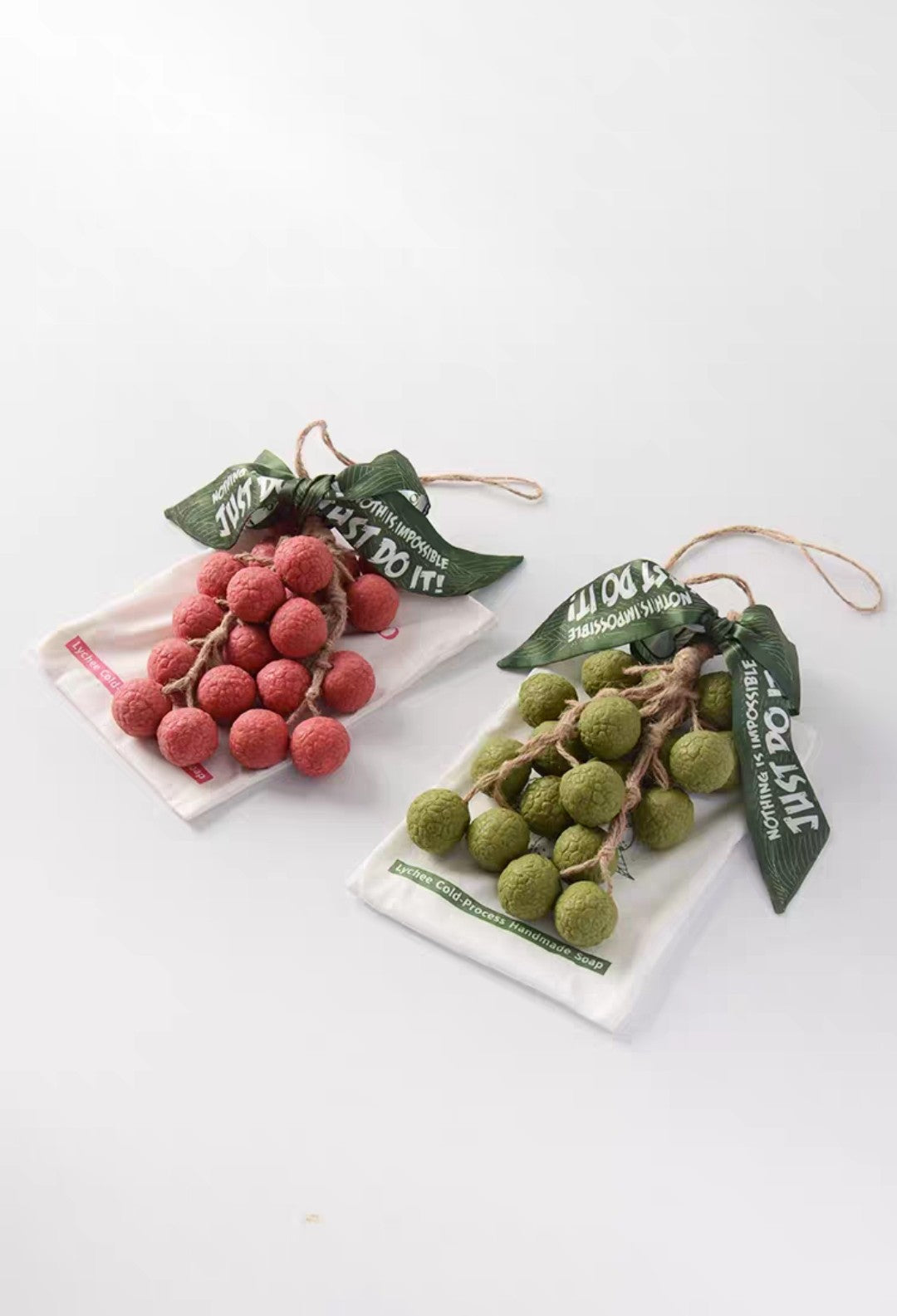Two decorative fruit ornaments on white backgrounds with green tags.