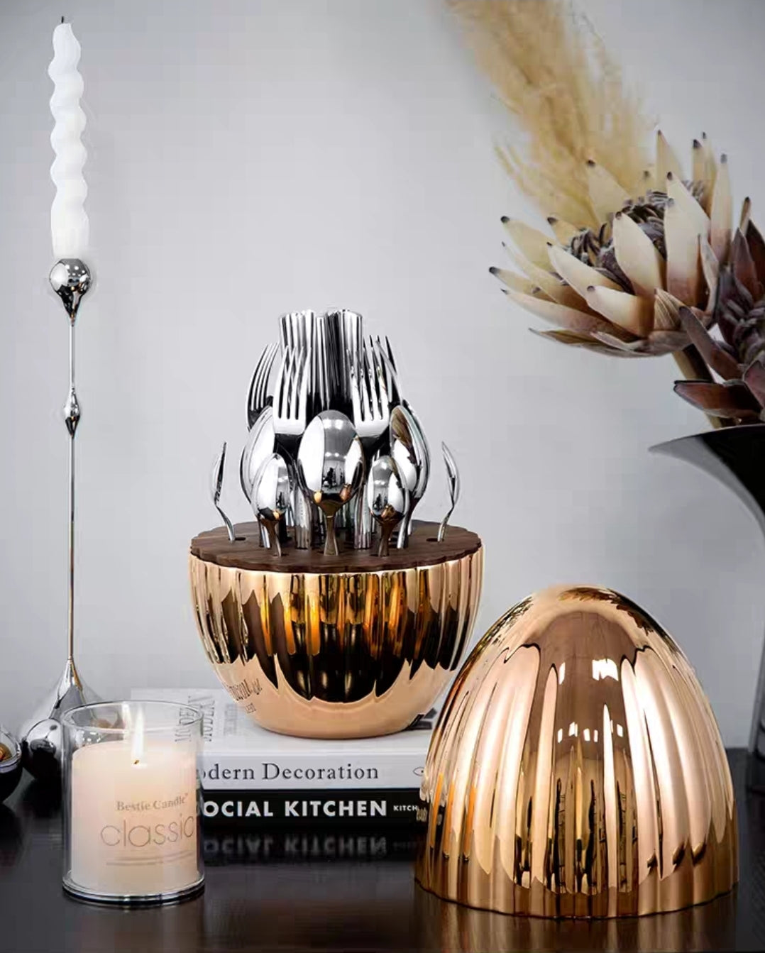 Sculptural egg-shaped utensil holder with polished stainless steel cutlery – elegant dining set