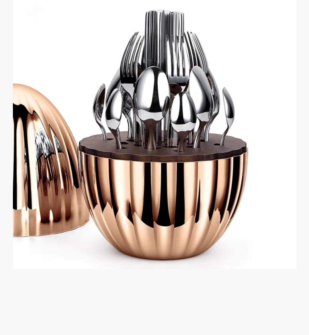 Stainless steel silverware set displayed in designer egg-shaped holder – modern 24-piece cutlery set