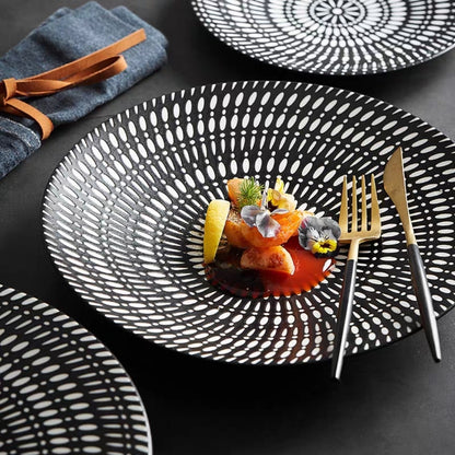 Top-down view of black embossed New Bone China dinner plate with circular Nordic-inspired pattern

