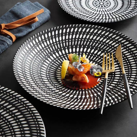 Top-down view of black embossed New Bone China dinner plate with circular Nordic-inspired pattern

