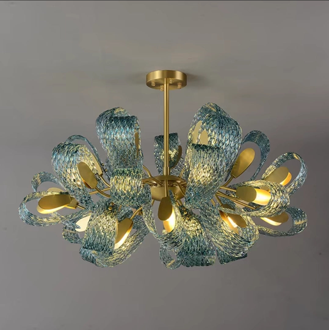12-head brushed brass chandelier styled in upscale dining room.

