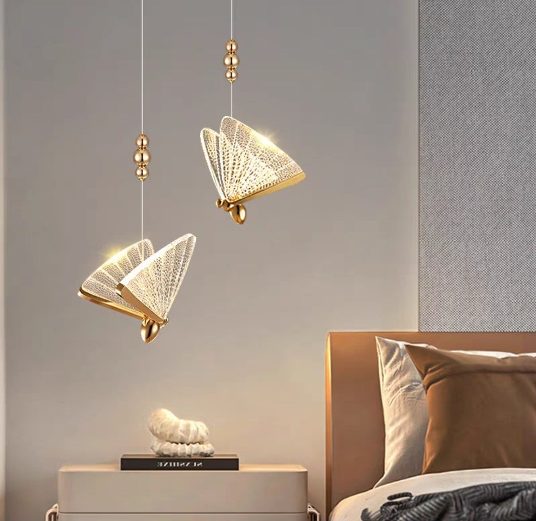 Decorative pendant lights hanging above a bed with a neutral wall background