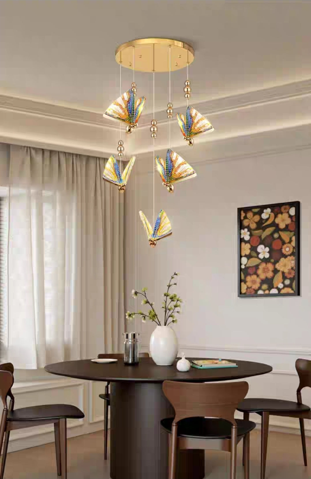 Dining room with a modern chandelier, round table, and chairs.