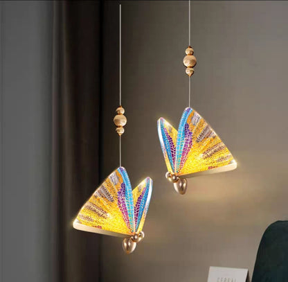 Close-up of abalone chandelier detailing with iridescent light reflection.