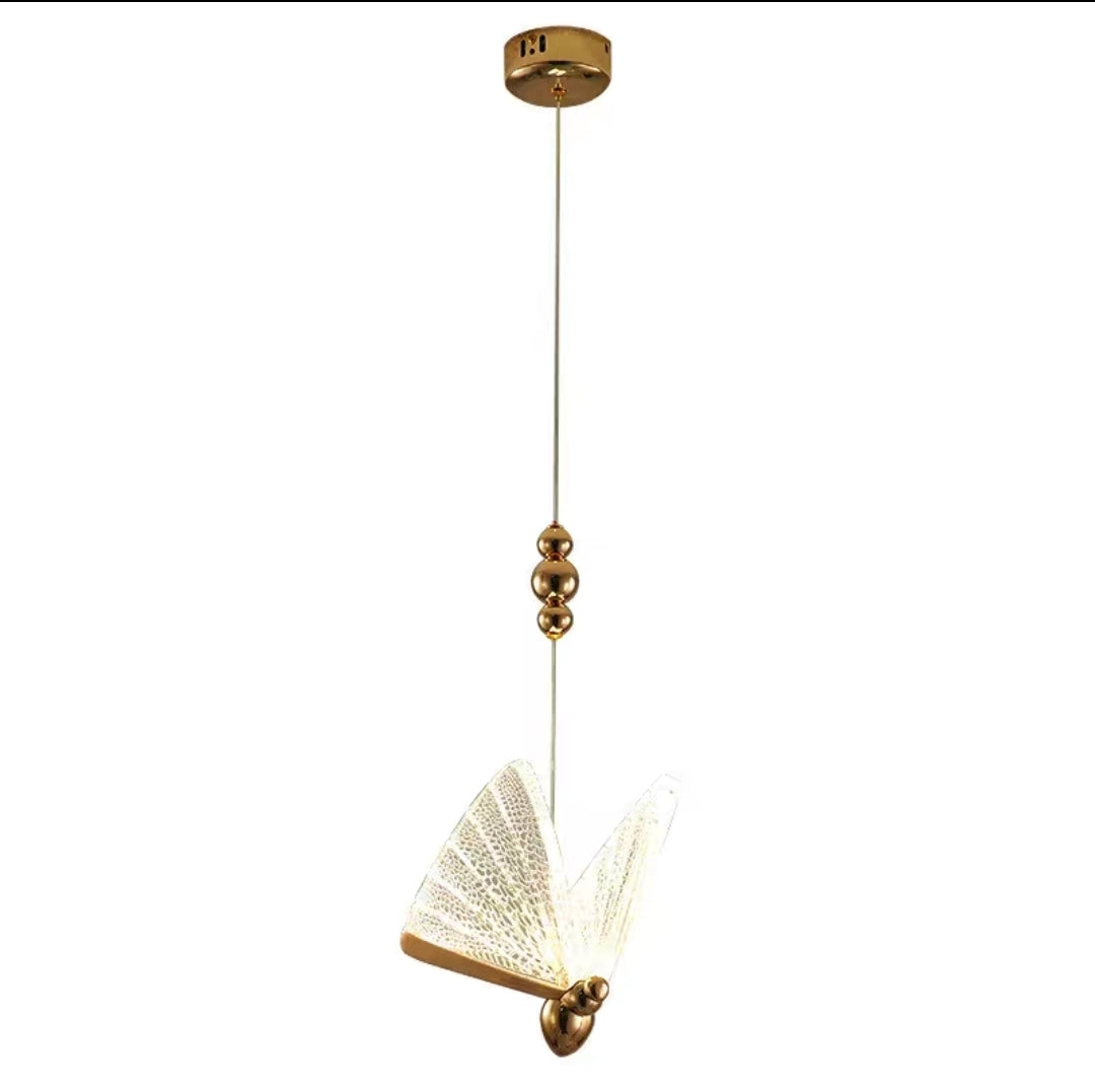 Gold pendant light with decorative design on a white background