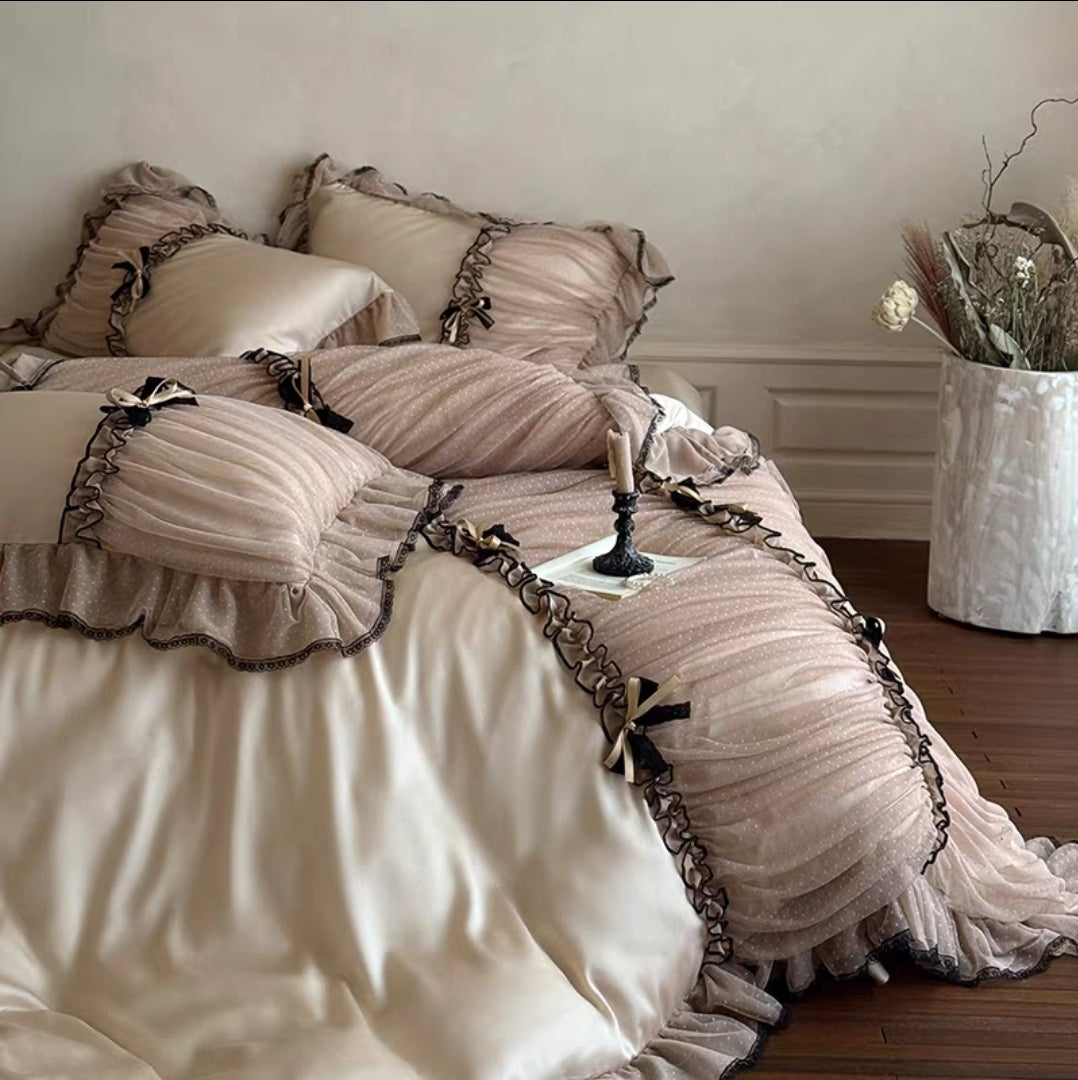 Full bed view showcasing the ruffled lace duvet cover in soft pastel pink.

