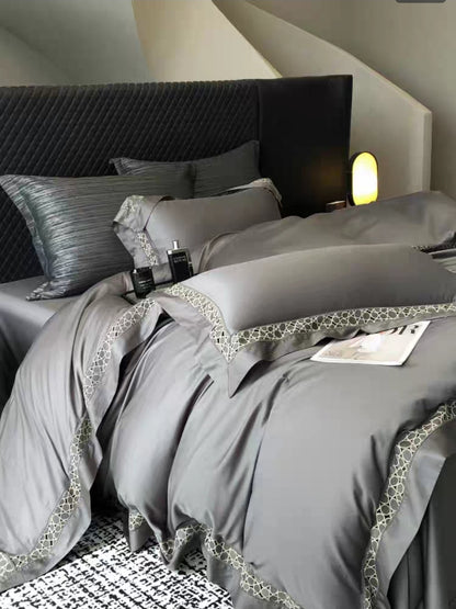 Deep grey 100S cotton bedding set on bed with matching sheets and pillows