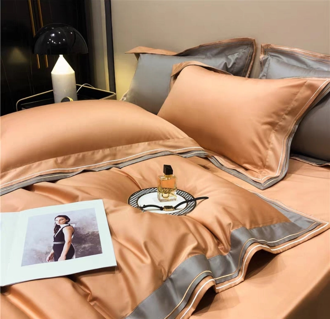 Rich red 4-piece luxury 100S long-staple cotton bedding set with geometric trim detail on duvet and pillows, styled on a black modern bed

