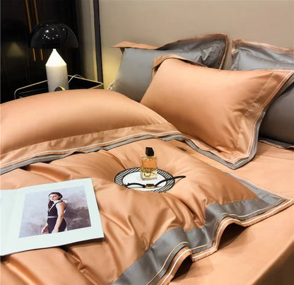Rich red 4-piece luxury 100S long-staple cotton bedding set with geometric trim detail on duvet and pillows, styled on a black modern bed

