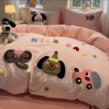 Children's bedroom with pink bedding featuring cartoon appliqués and plush toys.