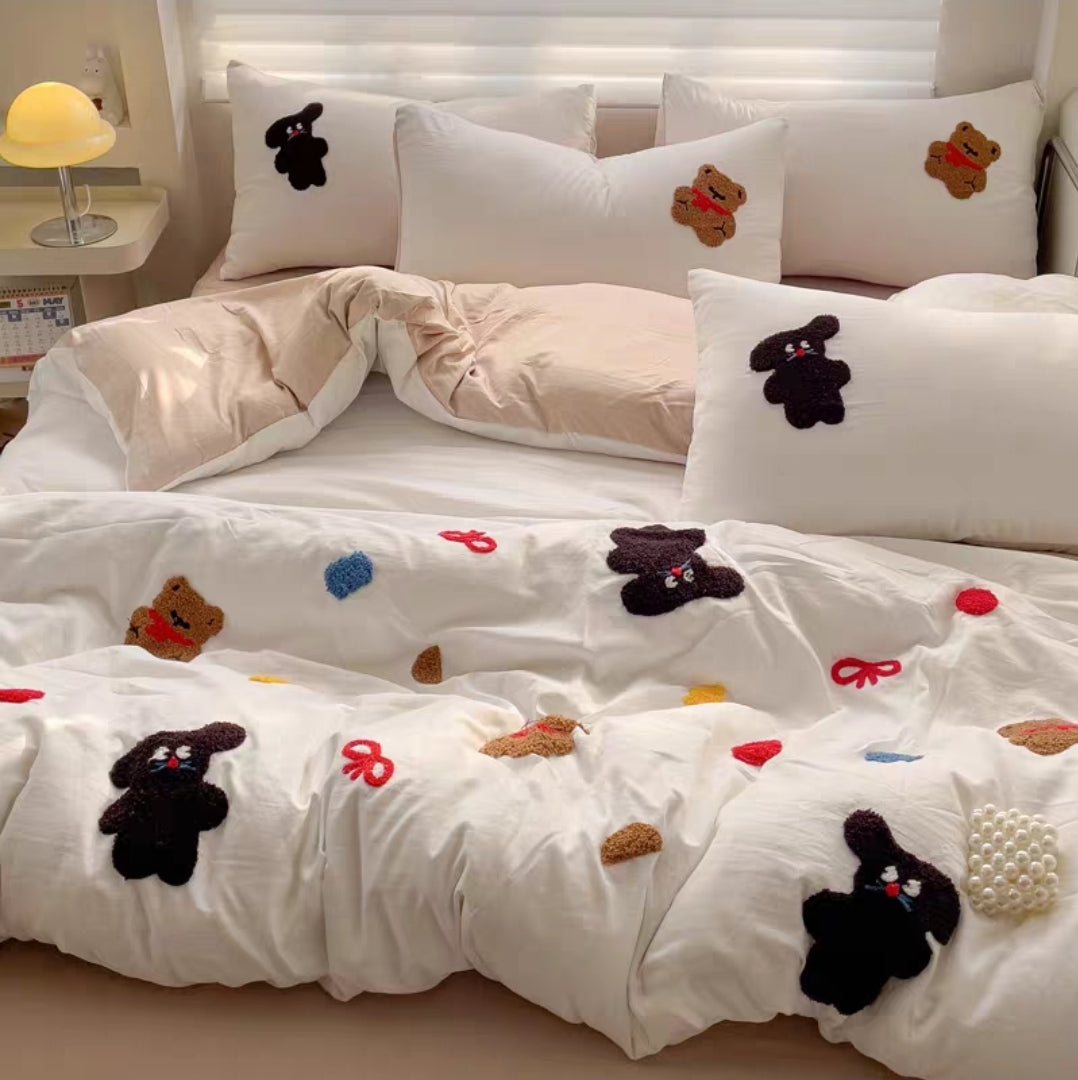Cotton Bedding set with cartoon character appliqués on a bed in a bedroom setting.