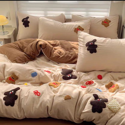 Cotton Bedding set with decorative pillows and a blanket featuring small teddy bear and flower appliqués.