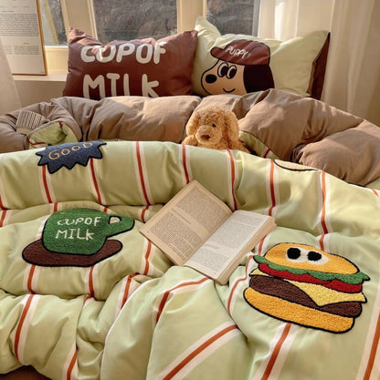 Children's room with a bedding set featuring cartoon pillowcases and a teddy bear.