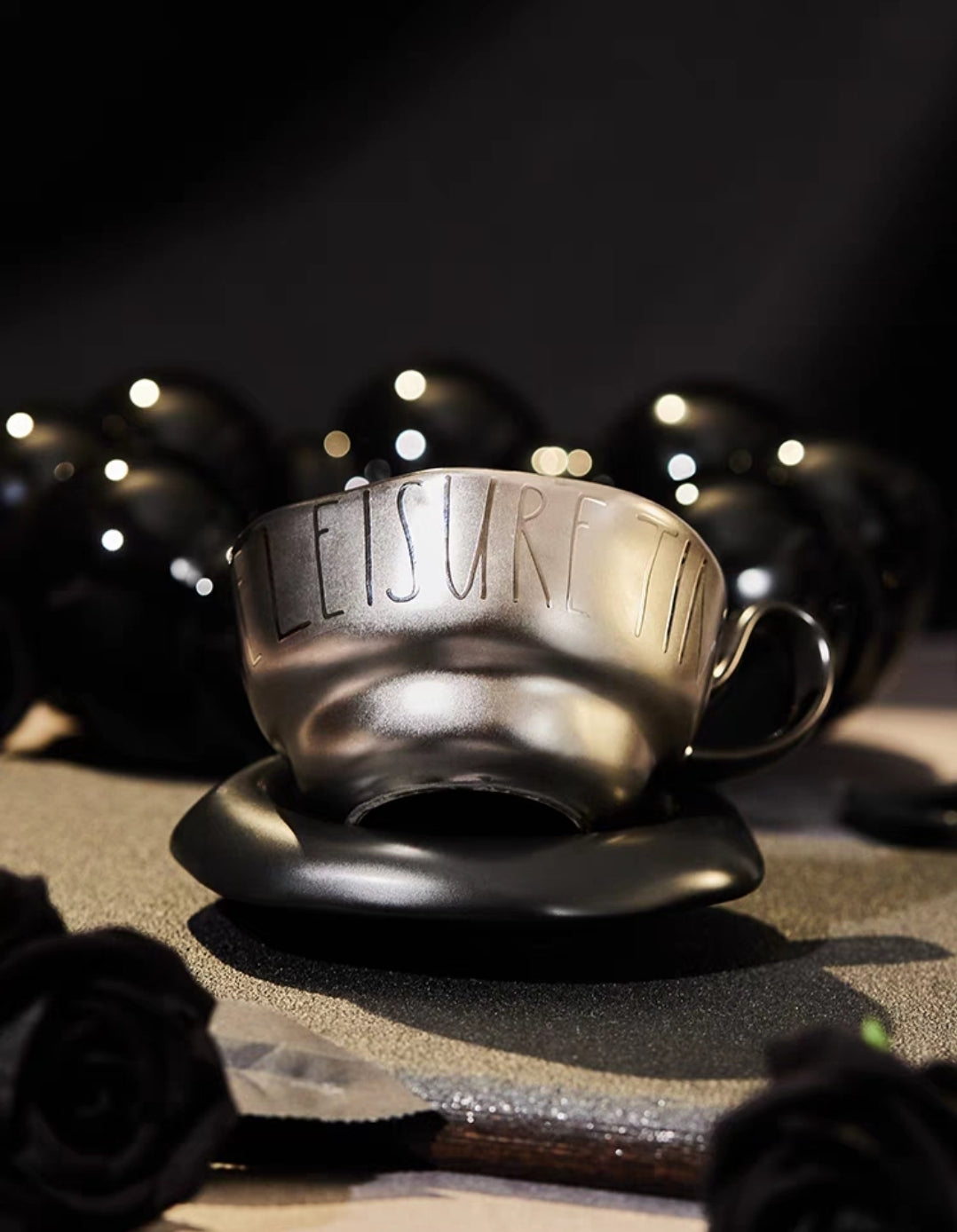 Black handcrafted ceramic coffee cup and saucer set with vintage glaze and ergonomic handle

