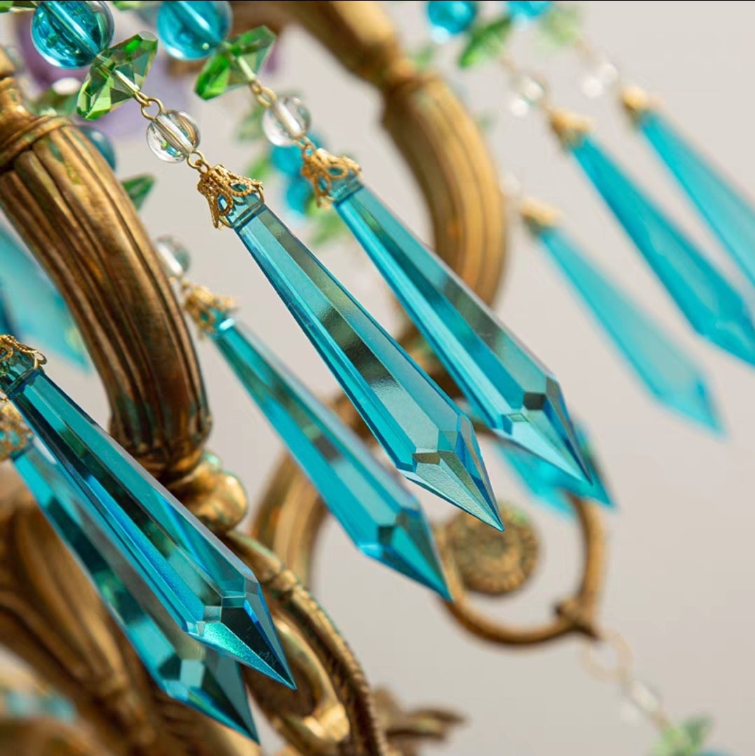 Close-up of Peacock-Inspired Brass Frame with Hanging Crystals