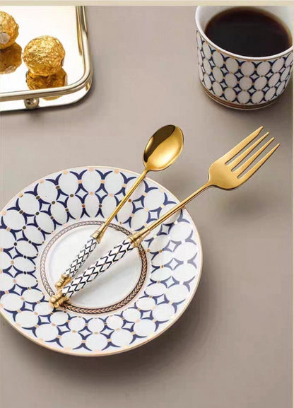 Luxury gold flatware with artisan ceramic handles displayed on table