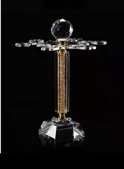 Crystal trophy with a central sphere and decorative elements on a black background
