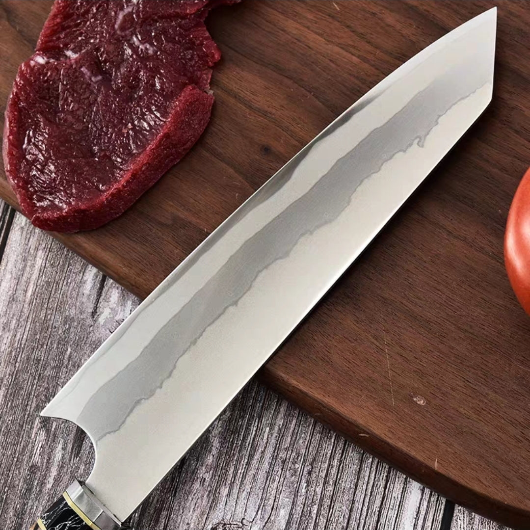 Close-up of Damascus knife blade slicing meat on a wooden cutting board


