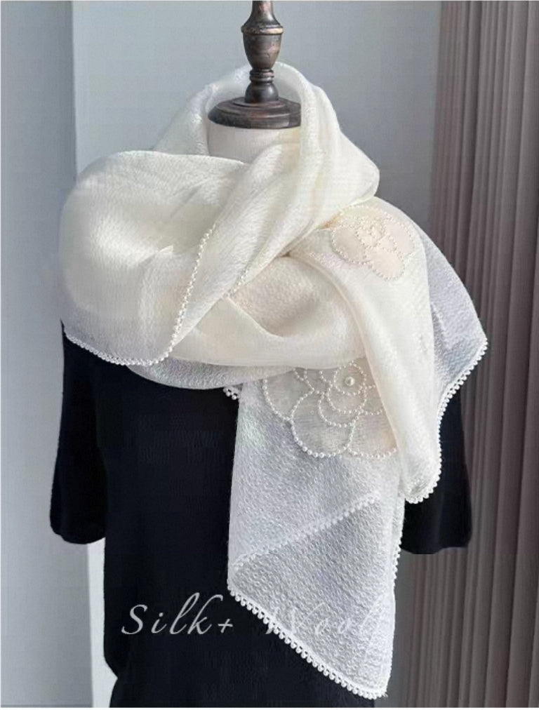 White camellia embroidered silk-wool shawl with delicate beaded trim.

